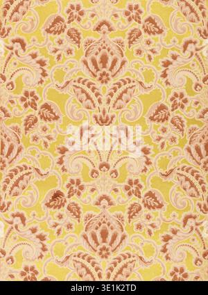 This vintage wallpaper pattern, likely from the 1920s or 1930s, features an ornate damask design in shades of brown and beige against a vibrant yellow background. The intricate floral and swirling motifs create a rich, decorative texture, reminiscent of historical textile patterns. Stock Photo