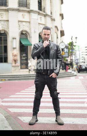 Confident bearded man wearing black leather jacket Stock Photo
