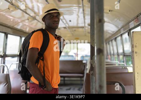 Young black African tourist man standing while riding the bus in Bangkok Thailand Stock Photo