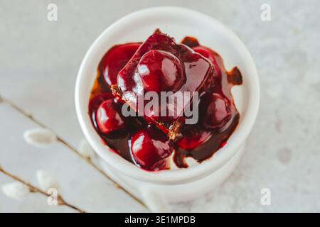 Homemade gluten and sugar free brownie with cherries on white mini cake plate, top view with copy space Stock Photo