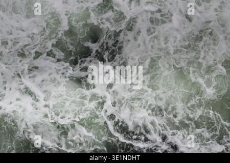 Big water splash seen from above a boat Stock Photo