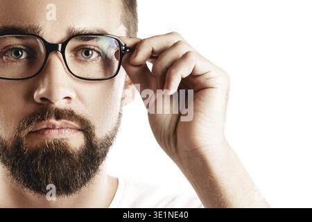 Young and handsome bearded man wearing eyeglasses on white background Stock Photo