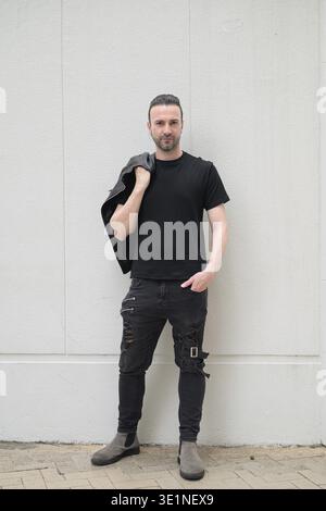 Confident bearded man wearing black leather jacket Stock Photo