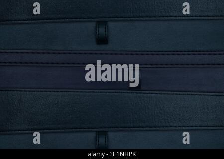 Full frame texture of overlapping black leather belt straps and loops Stock Photo