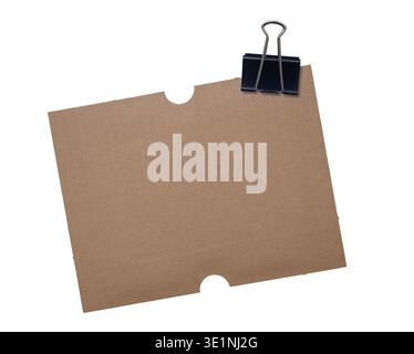 Piece of brown cardboard with black binder clip isolated on white background Stock Photo