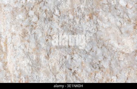 Close-up view of natural white quartz stone surface showcasing intricate textures and patterns, ideal for backgrounds or design elements in various Stock Photo