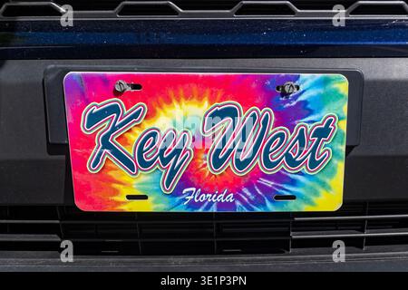 Island Vibes: Vibrant Tie-Dye Key West Souvenir License Plate on a Vehicle Grille Stock Photo