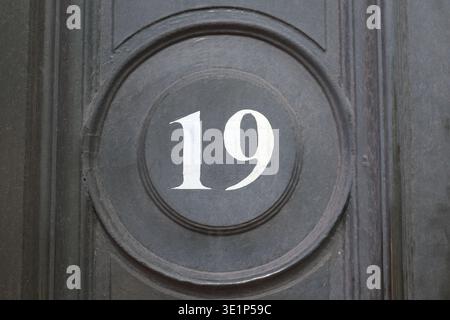 19 door number, white text on black background Stock Photo