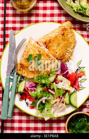 High-protein chicken calzone with cheese and fresh vegetable salad..selective focus Stock Photo