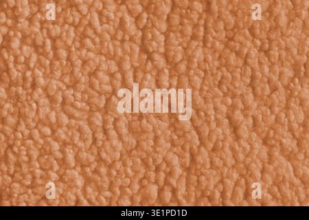 Vibrant orange color fabric texture of soft faux fur cloth with fluffy surface, abstract background. Close up, macro of shaggy fabric texture, upholst Stock Photo