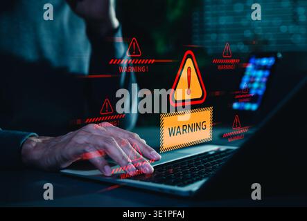 Cybersecurity warning alert concept. A person using laptop as digital threat notifications appear, representing malware attack, data breach risk, Stock Photo