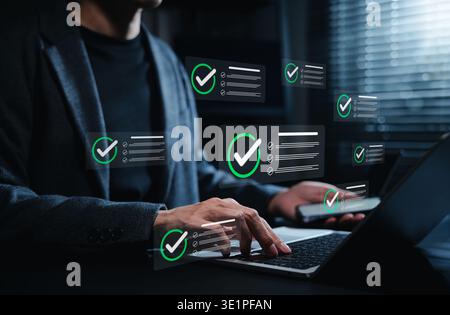 Digital checklist approval workflow concept. Businessman managing tasks on laptop and smartphone as verified task notifications appear, productivity, Stock Photo