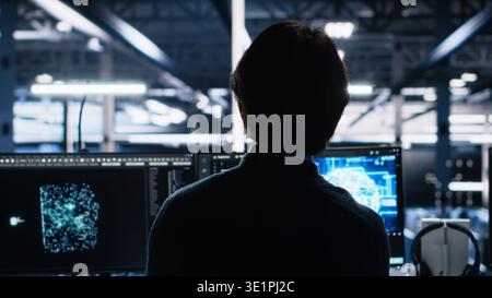 Admin in server room drinks coffee while using AI to review infrastructure diagnostics. IT specialist enjoys beverage in data center while analyzing performance with artificial intelligence, camera A Stock Photo