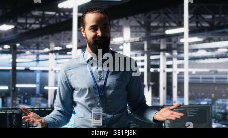 Data center manager showcasing AI technology, filming presentation video for audiences. Server farm team leader presenting artificial intelligence machine learning tech, camera A Stock Photo