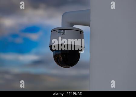 Outdoor Security Surveillance Camera Mounted Against Sky Stock Photo