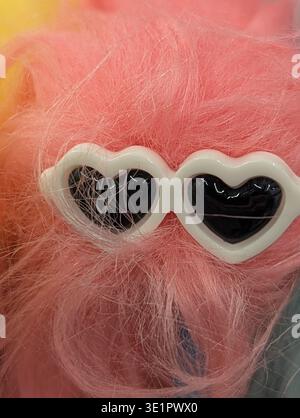 Pink Plush Wearing Heart Sunglasses, Studio Closeup Showing Soft Texture And White Frame With Black Lenses, Pastel Backdrop, Playful Romantic Mood Ide Stock Photo