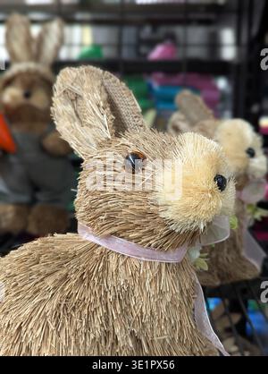 Straw Rabbit With Purple Ribbon, Shop Display Evoking Cottagecore And Farmhouse Charm, Natural Fiber Texture With Faux Fur Nose And Glass Bead Eyes, P Stock Photo