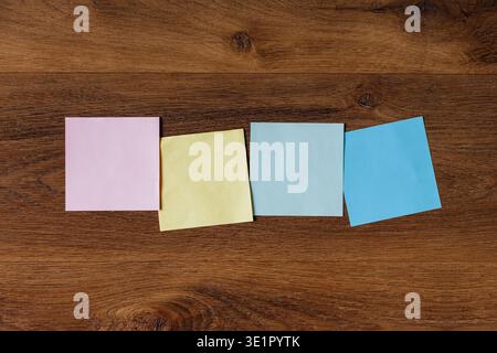 Colorful sticky notes on wooden table background with copy space, top view office reminder concept for mock up. Stock Photo