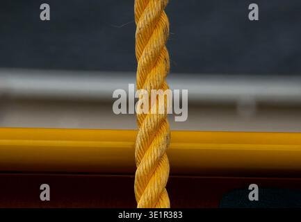 Yellow Polypropylene rope hanging down Stock Photo