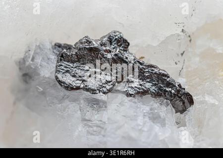 Closeup natural graphite crystalline ore on marble stone Stock Photo