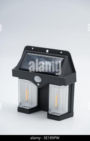 Solar Tungsten Wall Light Outdoor.  It features a built-in solar panel for charging by day and automatically turns on at dusk Stock Photo