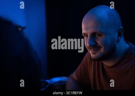 Portrait of a Smiling Man in Blue Light Stock Photo