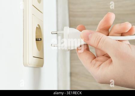 Hand holding electrical plug ready for power connection Stock Photo