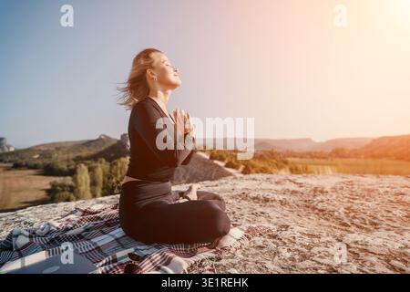 Woman Meditating on a Mountaintop Stock Photo