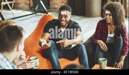 Group of Friends Enjoying a Fun Game Night With Laughter and Conversation in a Cozy Setting Stock Photo