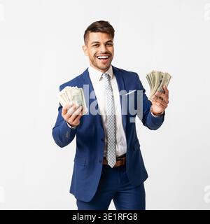 Excited Hispanic Businessman Holding Bunch Of Money Over White Background Stock Photo