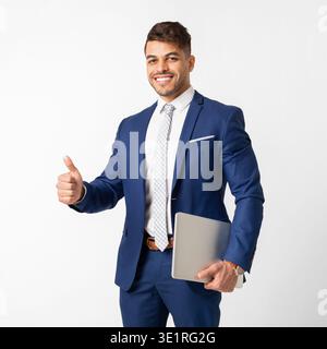 Smiling Arab Businessman Holding Tablet And Showing Thumb Up Stock Photo