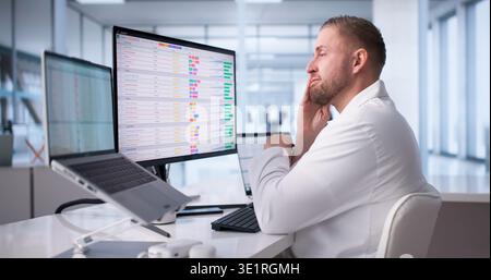 Physician Frustrated While Navigating Hospital Computer Systems Stock Photo