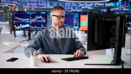 Investor Analyzes Several Monitors Displaying Live Financial Market Information Stock Photo