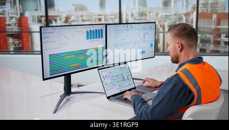 Engineer Oversees Automated Gas And Oil Processing System Via Computer Monitoring Stock Photo