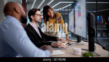 Diverse Team Using Computers To Analyze Data And Manage Business Performance, Possibly As Analysts, Managers Stock Photo
