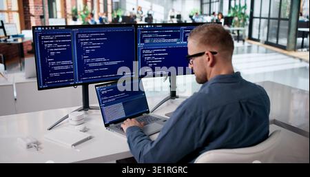 Dedicated Programmer Developing Innovative Software At Workstation Stock Photo