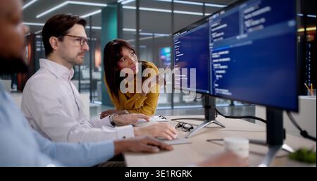 Diverse Team Of Software Developers Coding, Collaborating, And Leading Projects. Many Programmers, Engineers Stock Photo