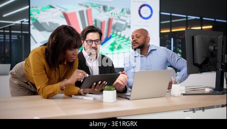 Diverse Team Of Urban Planners And Engineers Using GIS And BIM Software, Collaborating On 3D Property Mapping Stock Photo