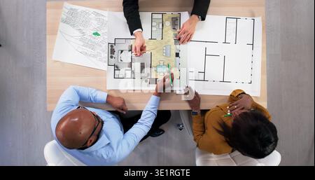 Real Estate Consultant And Interior Designer Discussing Apartment Remodel Plans. An Engineer Stock Photo