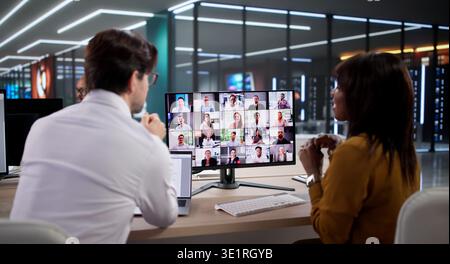 Person In Modern Office Using Laptop During Virtual Business Conference Call, Collaborating Online Stock Photo
