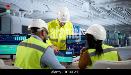 Diverse Team Of Engineers And Technicians Meet At Factory Desks Checking Automated Industrial Systems Stock Photo