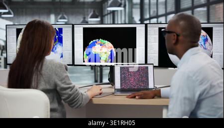 Scientists And Meteorologists Analyze Hurricane Data On Computers In Office. A Male Stock Photo