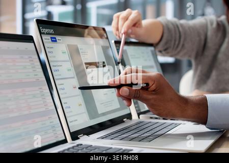 An African Finance Manager Uses Expense Management Software On Laptop Tracking Costs Stock Photo