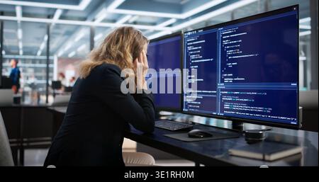 The Sad Web Developer At Her Boring Desk Coding Software Stock Photo