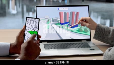 Young Engineer And Architect Review 3D Maps On Laptops Together. The Woman Uses A Smartphone Stock Photo