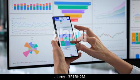 Woman Using Smartphone To Analyze Business Data As Financial Analyst. Stock Photo
