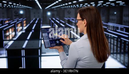 Female Data Specialist Monitors Cloud Servers For Security In High-Tech Facility Stock Photo