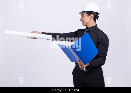 Engineer pointing with document folder to the side Stock Photo