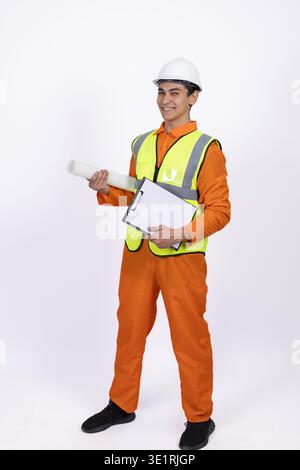 Construction worker pointing and holding a tablet Stock Photo