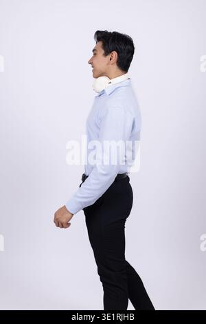 Young professional man walking in side profile view Stock Photo